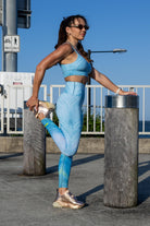 Side angle of Zokkibee blue tiger leggings and crop top highlighting stretch fabric and striking design