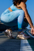 Side angle of Zokkibee blue tiger leggings and crop top highlighting stretch fabric and striking design