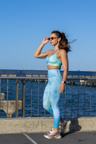 Side angle of Zokkibee blue tiger leggings and crop top highlighting stretch fabric and striking design