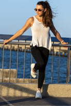 Front view of Zokkibee Molinier white rayon knitted tank top with side clip feature for a cinched waist.