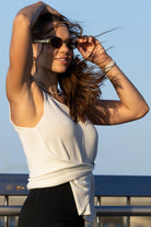 Side angle of Zokkibee Molinier white rayon knitted tank top showing waist-cinching clip detail.