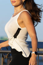Side angle of Zokkibee Molinier white rayon knitted tank top showing waist-cinching clip detail.