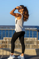 Side angle of Zokkibee Molinier white rayon knitted tank top showing waist-cinching clip detail.