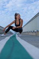 Front view of Zokkibee Onyx crop top and leggings set in solid black with high-waisted fit