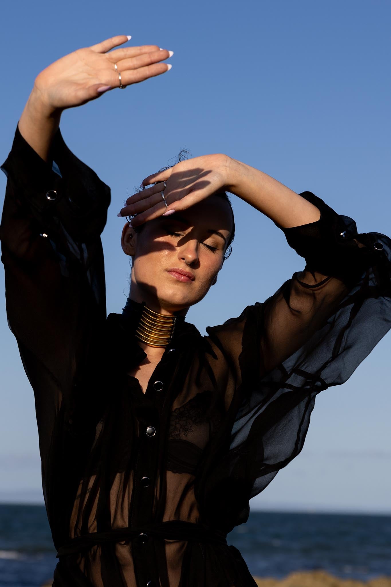 Front view of Zokkibee Asanti choker necklace with leather band and gold plated brass accents