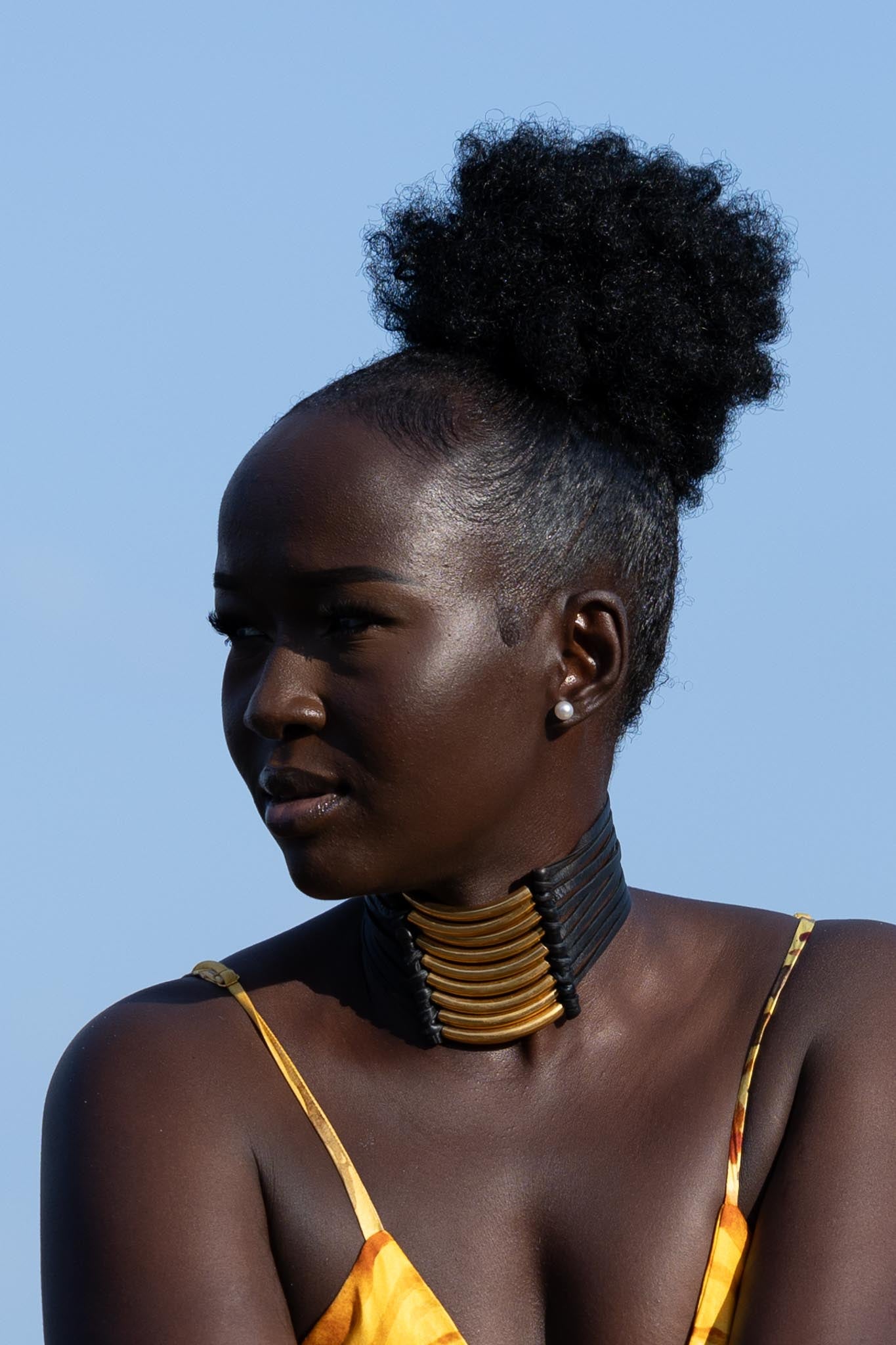Front view of Zokkibee Asanti choker necklace with leather band and gold plated brass accents