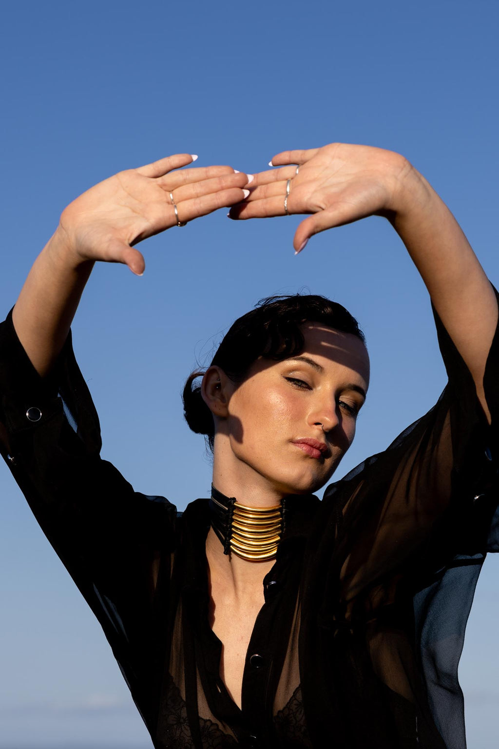 Front view of Zokkibee Asanti choker necklace with leather band and gold plated brass accents