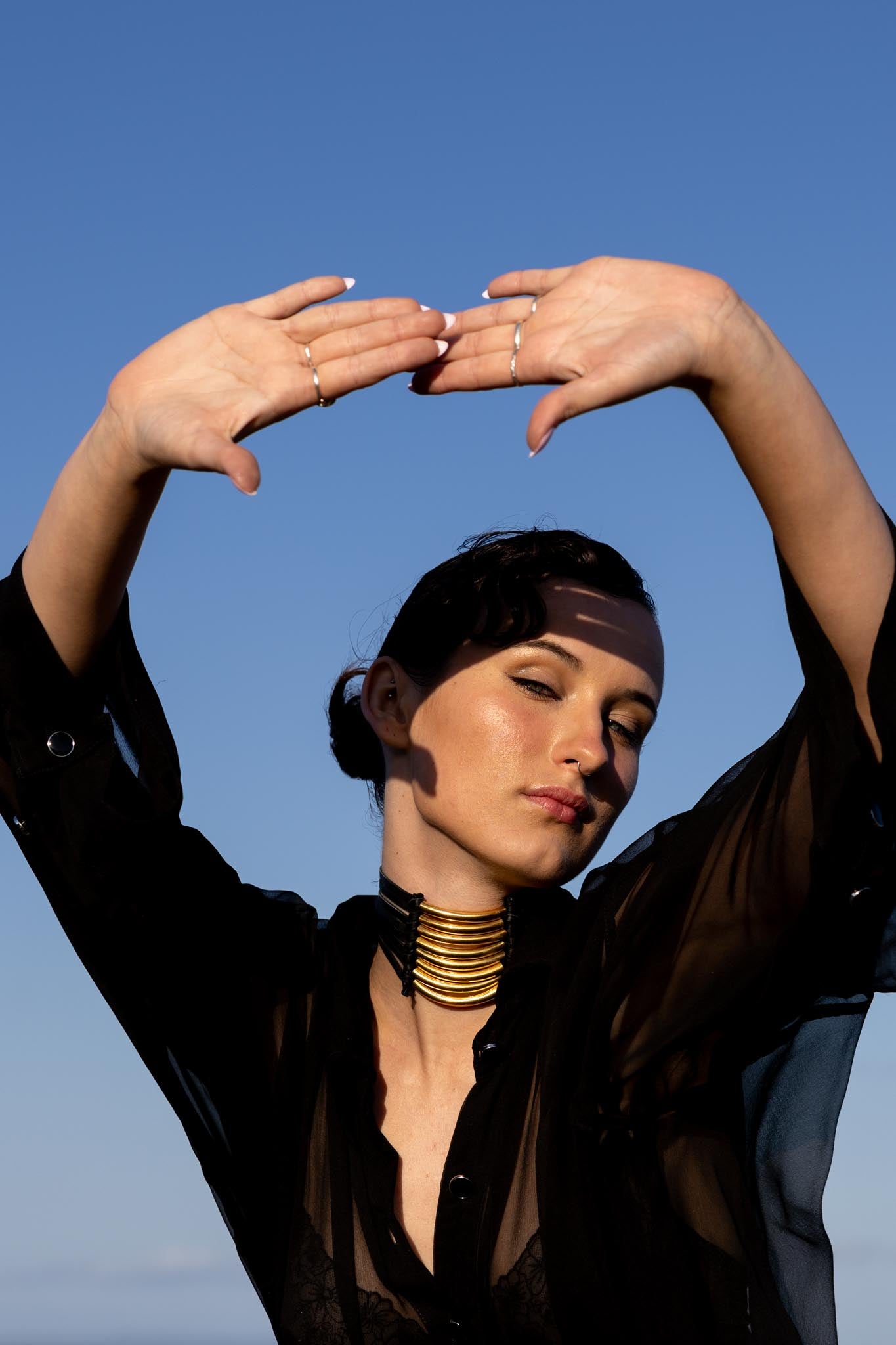 Front view of Zokkibee Asanti choker necklace with leather band and gold plated brass accents