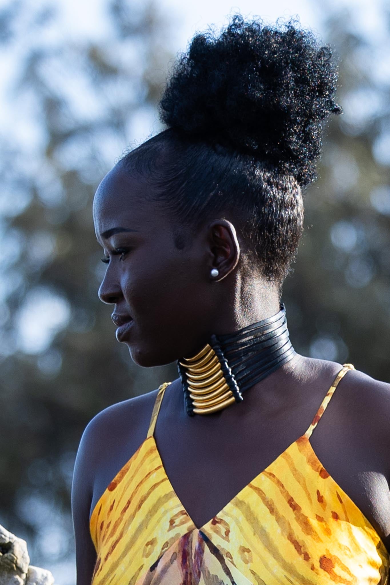 Side angle of Zokkibee Asanti choker necklace with layered leather and gold plated brass detail