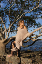 Front view of Zokkibee asymmetric knitted top with unique asymmetric cut and textured knit