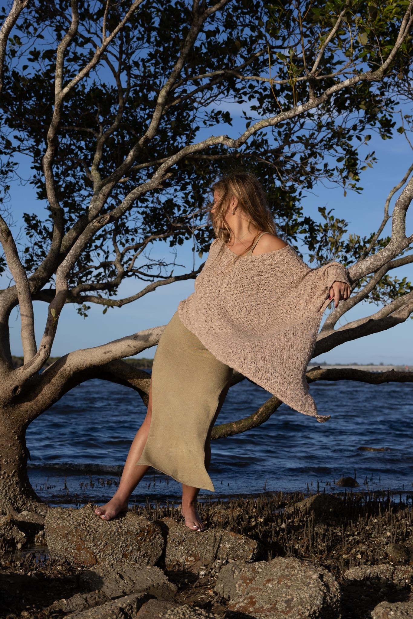 Front view of Zokkibee asymmetric knitted top with unique asymmetric cut and textured knit