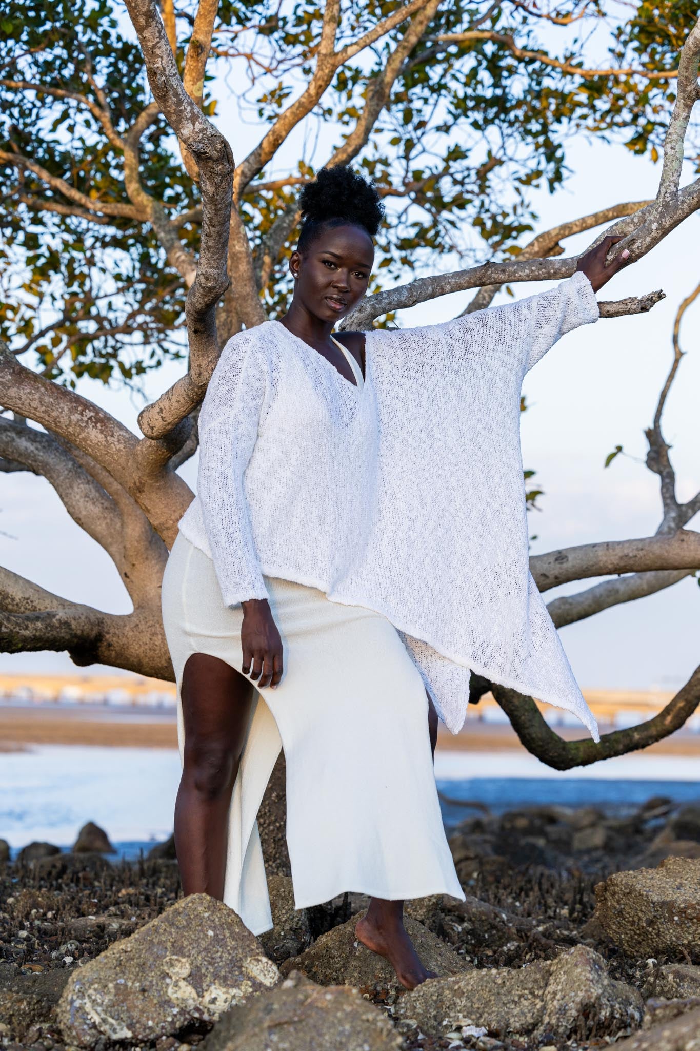 Front view of Zokkibee asymmetric knitted top with unique asymmetric cut and textured knit