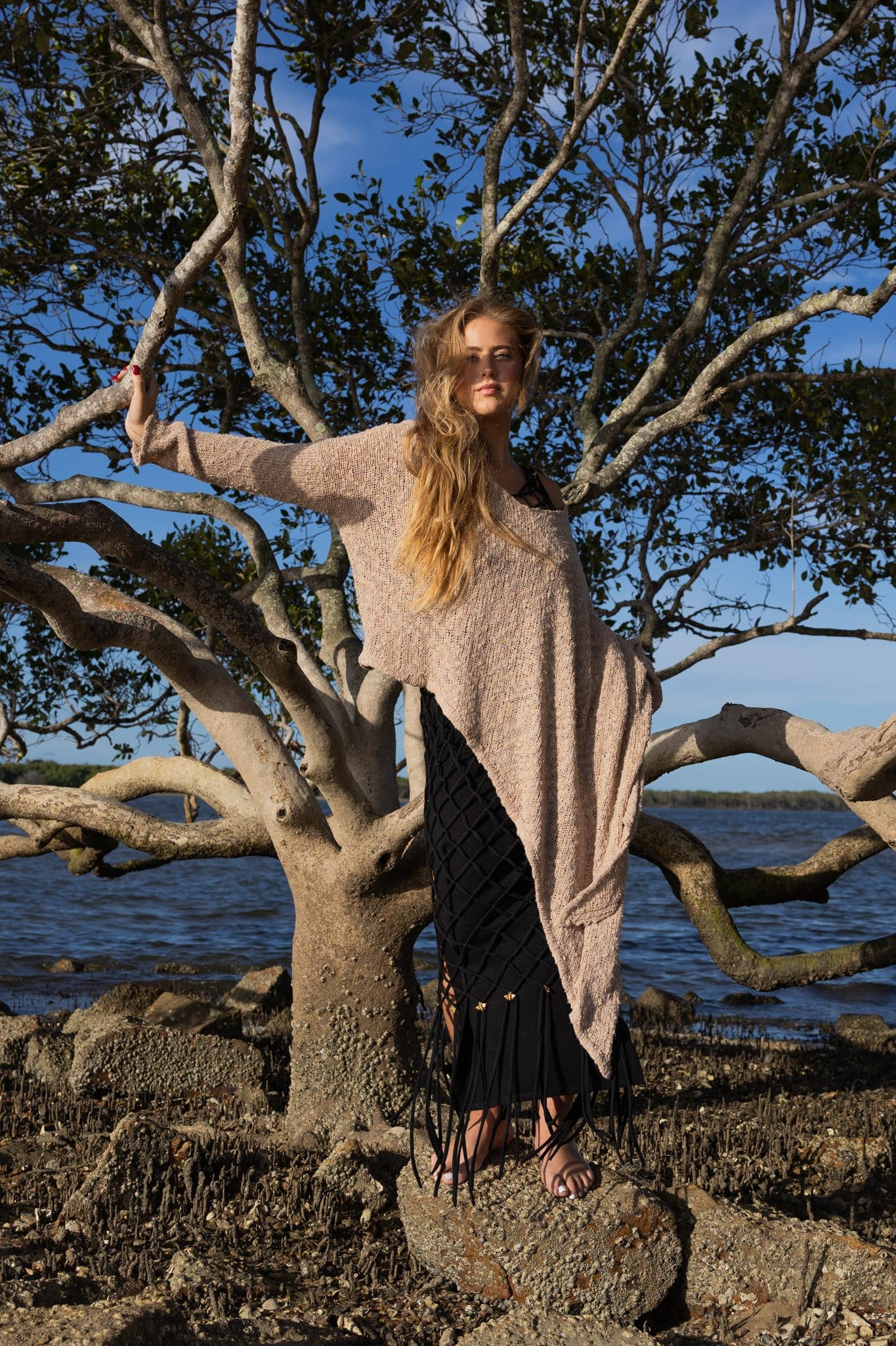 Model wearing Zokkibee asymmetric knitted top with unique asymmetric cut styled for modern, chic fashion