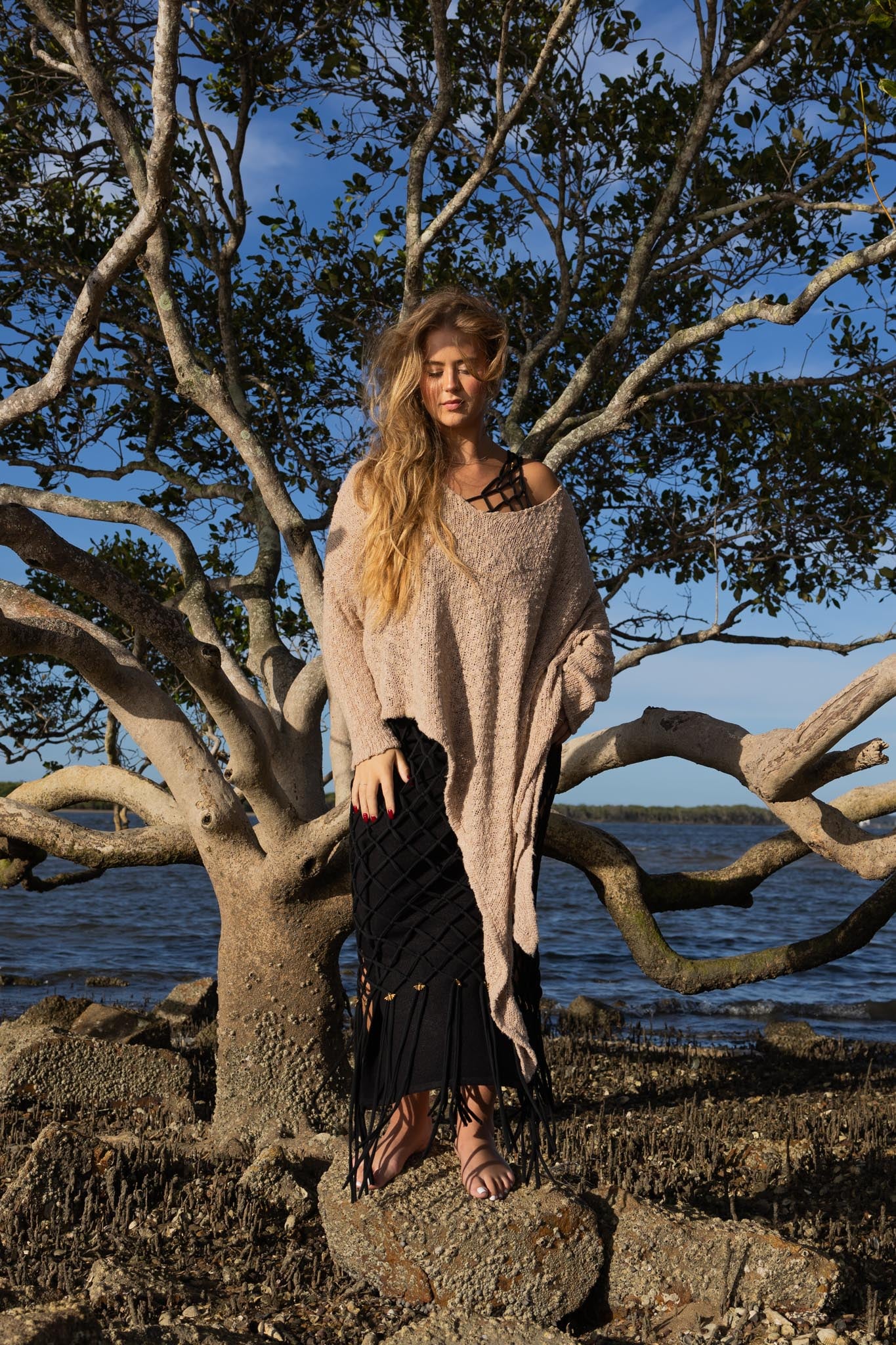 Front view of Zokkibee asymmetric knitted top with unique asymmetric cut and textured knit