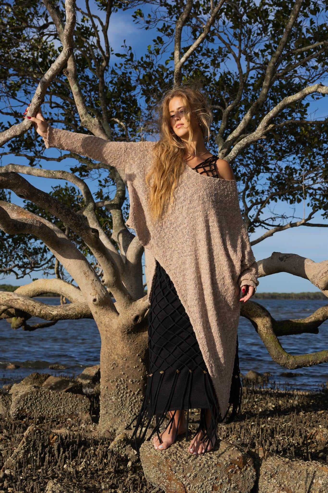 Front view of Zokkibee asymmetric knitted top with unique asymmetric cut and textured knit