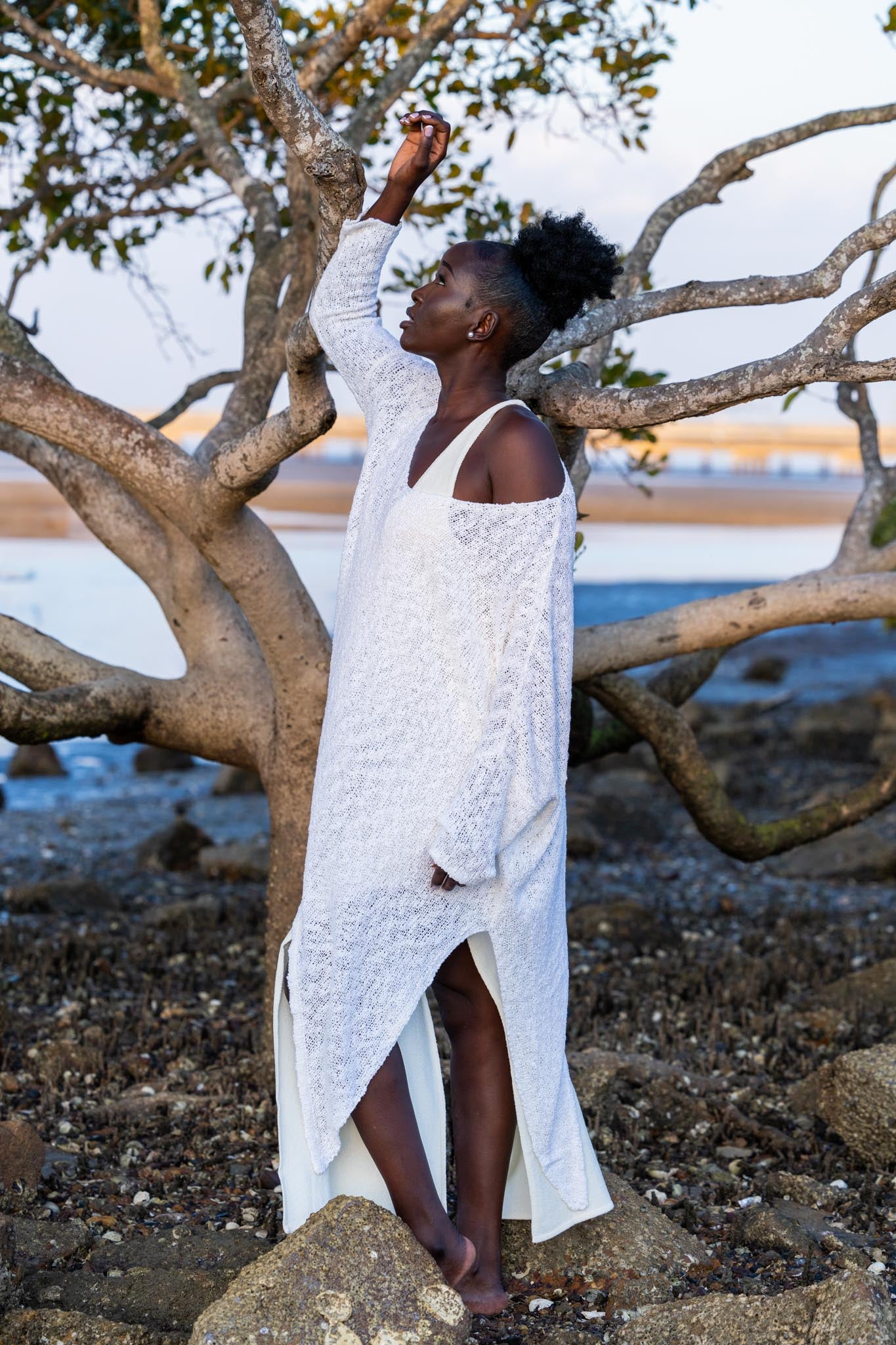 Side angle of Zokkibee asymmetric knitted top highlighting unique asymmetric cut