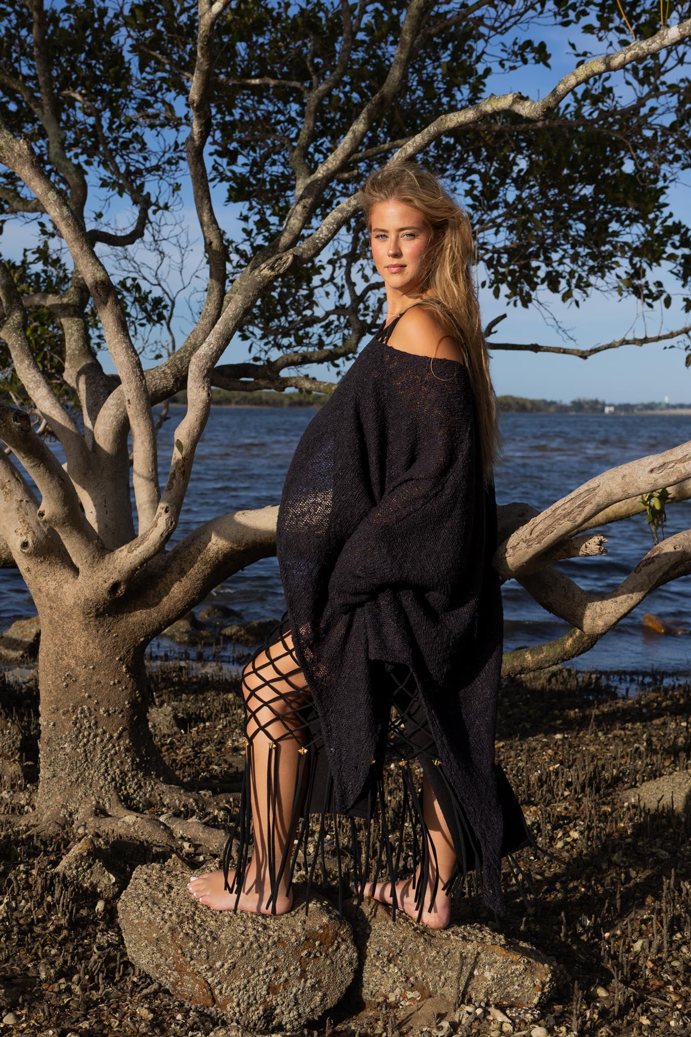 Side angle of Zokkibee asymmetric knitted top highlighting unique asymmetric cut