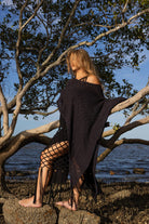 Side angle of Zokkibee asymmetric knitted top highlighting unique asymmetric cut