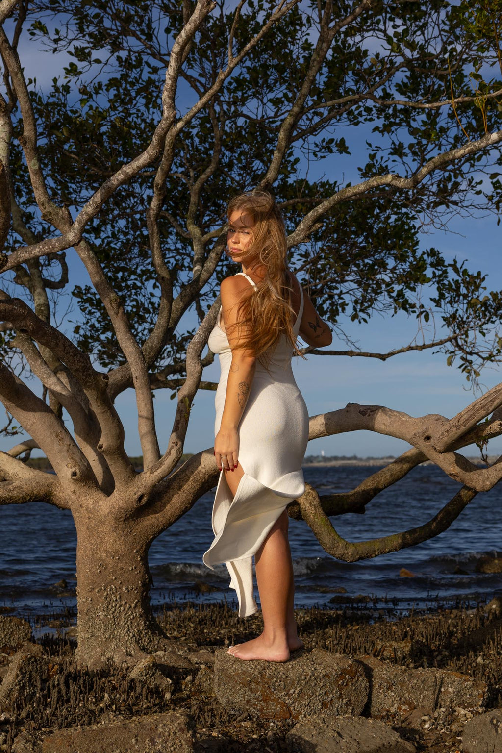 Side angle of Zokkibee Bianca cotton dress with fitted knitted silhouette