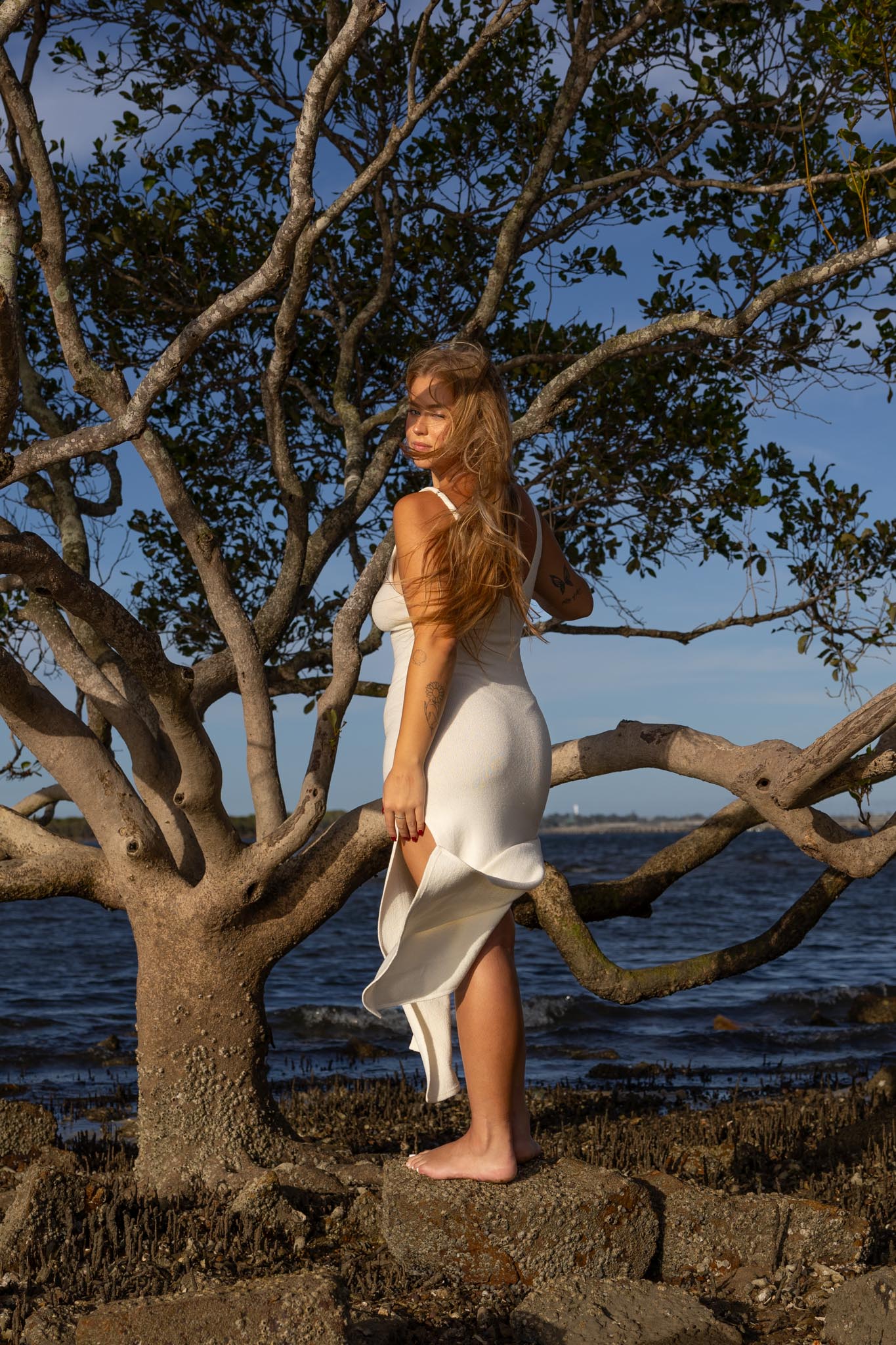 Side angle of Zokkibee Bianca cotton dress with fitted knitted silhouette