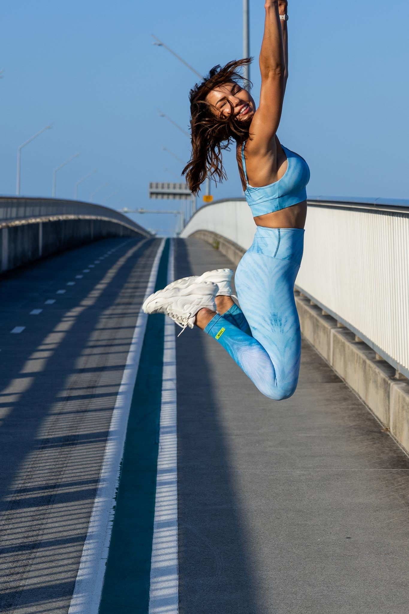 Side angle of Zokkibee blue tiger leggings and crop top highlighting stretch fabric and striking design