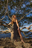 Back view of Inka Obsidian fringe dress showing black fringe details and handcrafted macramé knots.
