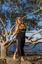 Front view of Zokkibee Inka Obsidian fringe dress in black with artisan macramé knots and dramatic fringe.