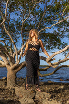 Front view of Zokkibee Inka Obsidian fringe dress in black with artisan macramé knots and dramatic fringe.