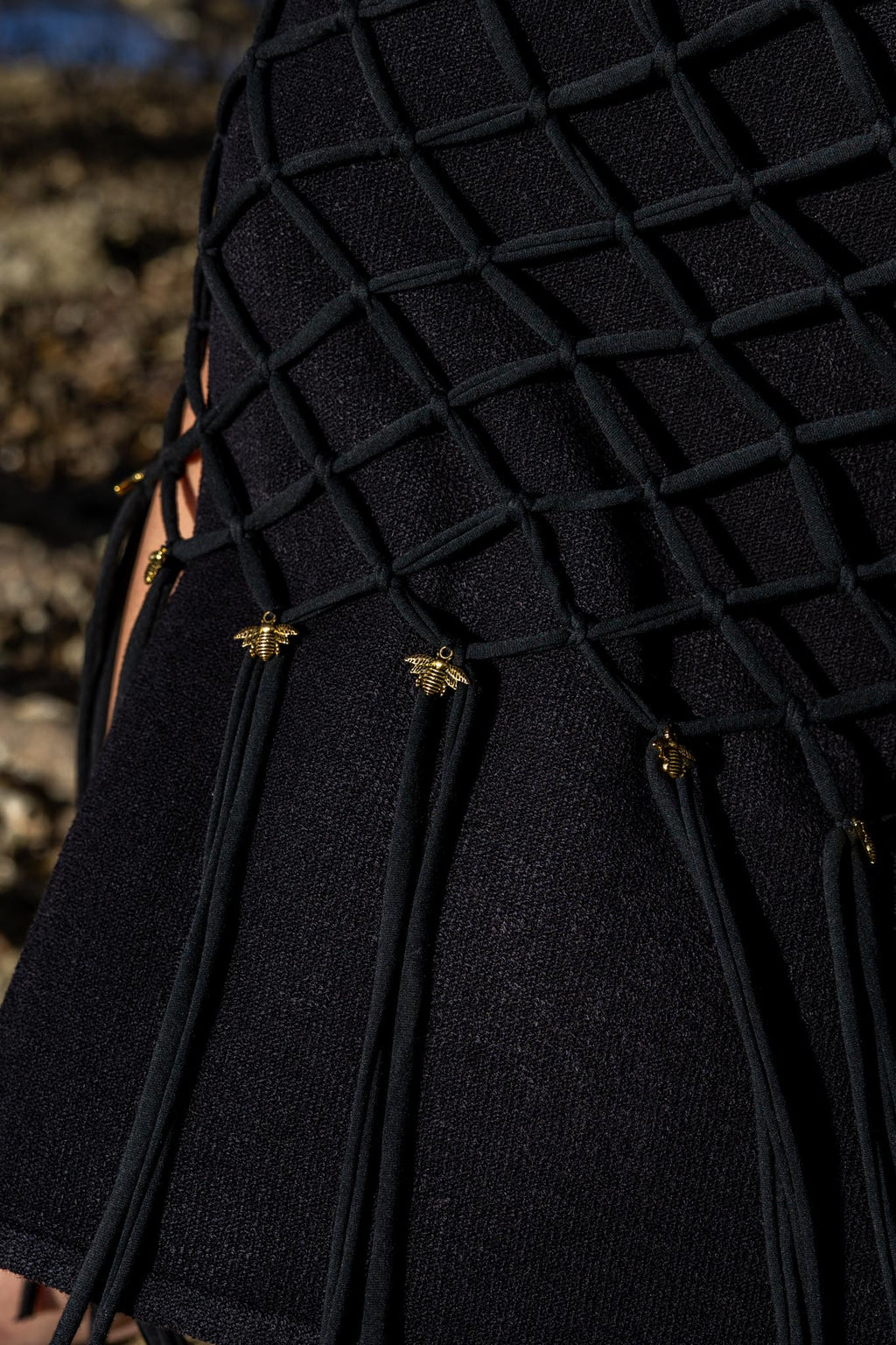 Closeup of artisan macramé knots on Zokkibee Inka Obsidian black fringe dress.