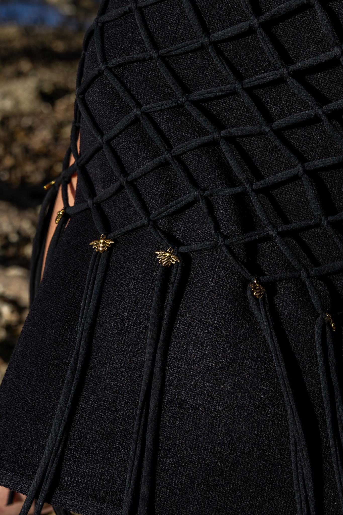 Closeup of artisan macramé knots on Zokkibee Inka Obsidian black fringe dress.
