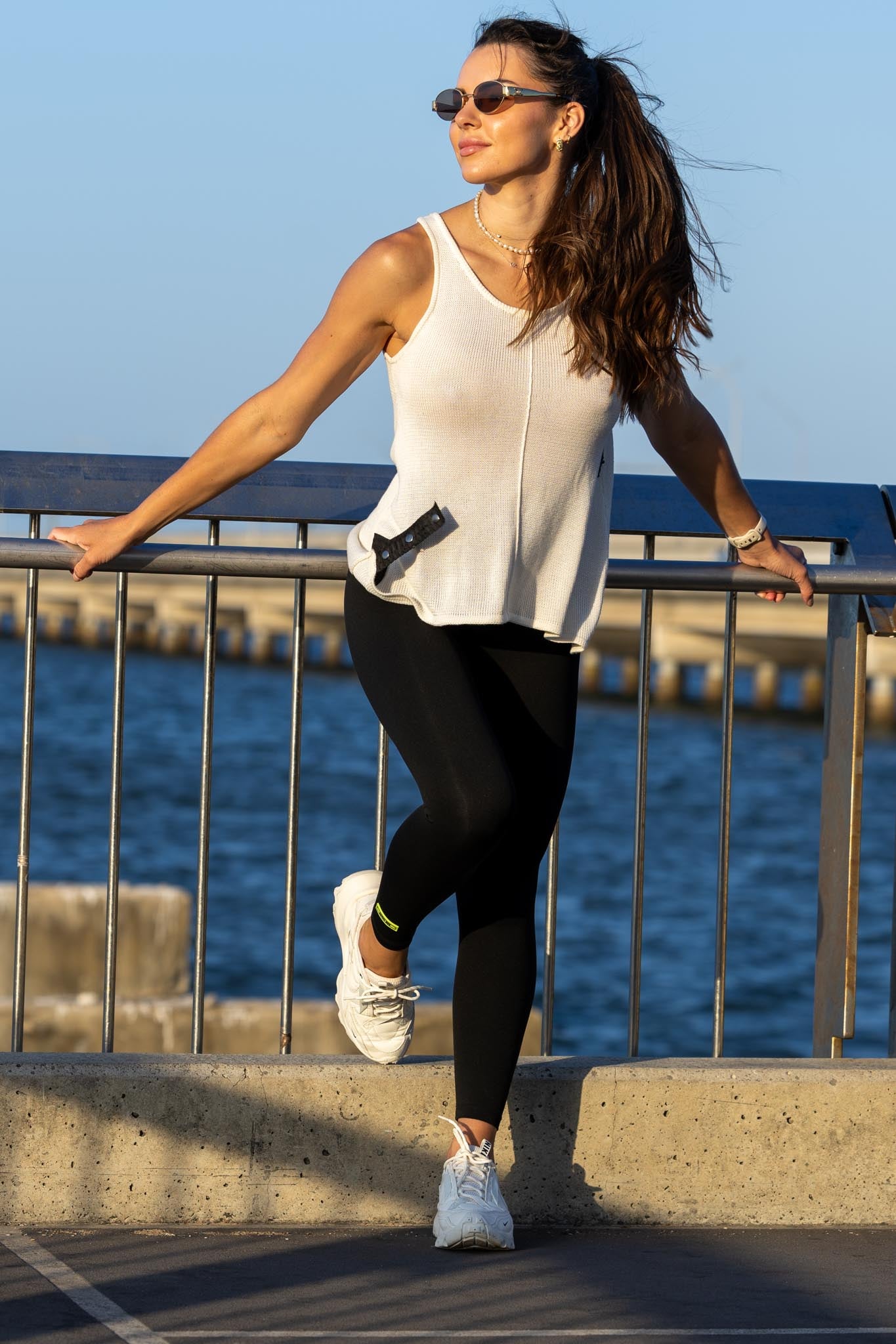 Front view of Zokkibee Molinier white rayon knitted tank top with side clip feature for a cinched waist.