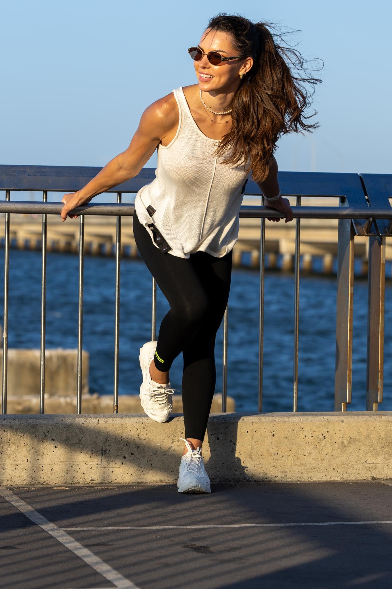 Front view of Zokkibee Molinier white rayon knitted tank top with side clip feature for a cinched waist.