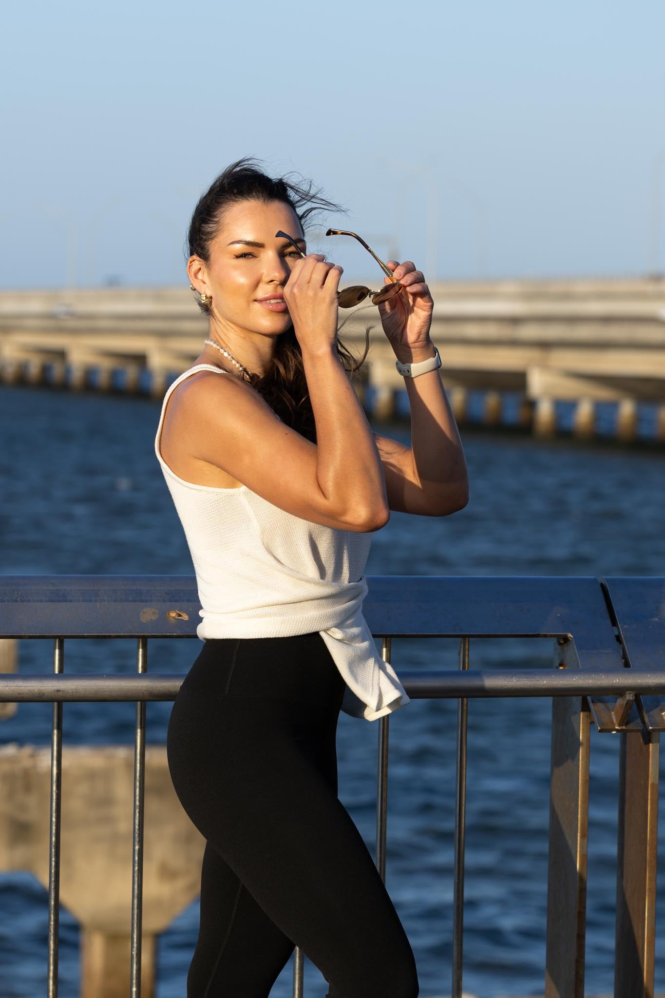 Side angle of Zokkibee Molinier white rayon knitted tank top showing waist-cinching clip detail.
