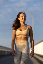 Model wearing Zokkibee Nomad leggings and matching crop top styled for active or statement fashion