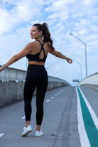 Back view of Onyx crop top and leggings set showing fitted silhouette and sleek black design