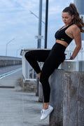 Side angle of Zokkibee Onyx crop top and leggings set highlighting stretch fabric and streamlined style
