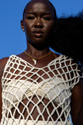 Model wearing Zokkibee shark tooth necklace with gold chain styled for modern, bold fashion